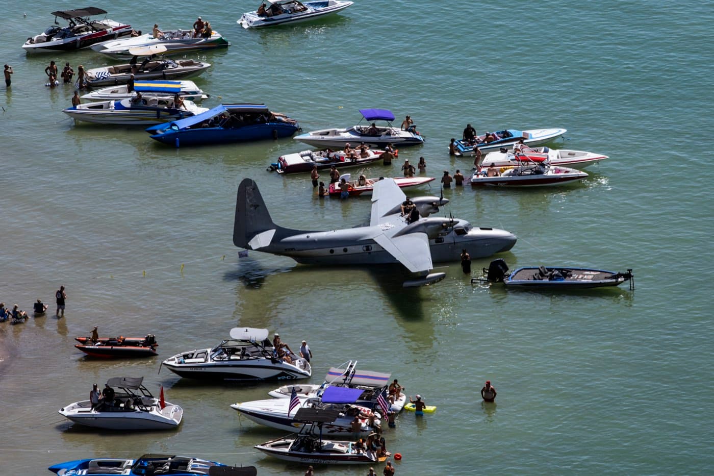 A seaplane moored among the boats in the cove